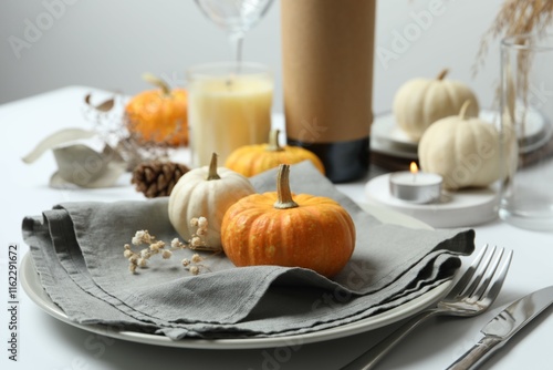 Rustic holiday table setup with plates, cutlery and autumn decorations photo