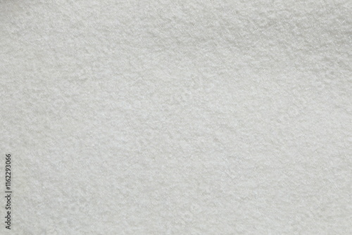 White cuddle teddy bear fabric as background, top view