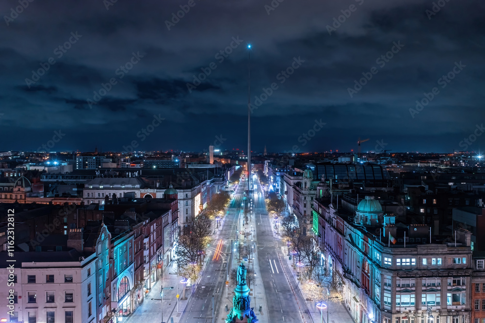 Fototapeta premium Aerial view of O'Connell Street at night, featuring the iconic Spire at the center