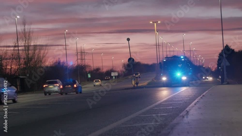 UK fire engine responding to emergency, flashing lights. 