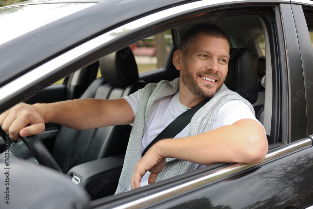 Man driving modern car, view through window Man driving modern car, view through window