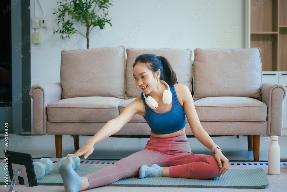 An Asian teenage girl exercises in her room to relax, stretch, and improve health.Regular exercise enhances endurance,strength, balance, emotional control, fitness, and aids in effective weight loss An Asian teenage girl exercises in her room to relax, stretch, and improve health.Regular exercise enhances endurance,strength, balance, emotional control, fitness, and aids in effective weight loss