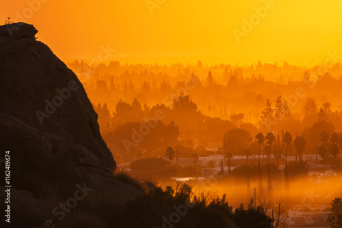 Foggy orange sunburst sunrise.  Photograph taken near Santa Susana Pass State Historic Park in the Chatsworth area of the San Fernando Valley in Los Angeles California. photo