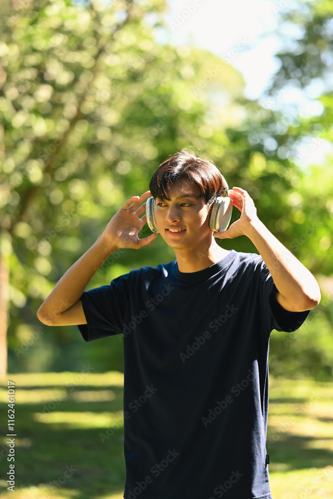 Portrait of male runner taking a break and listening music on headphones Portrait of male runner taking a break and listening music on headphones