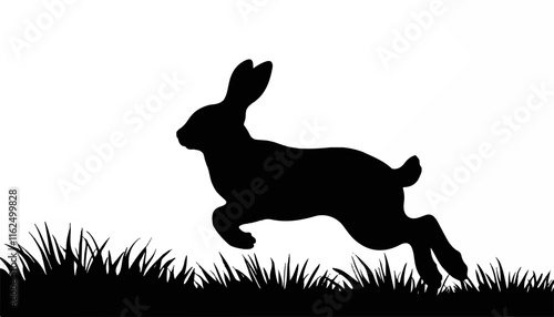 Silhouette of a jumping rabbit in grassy field