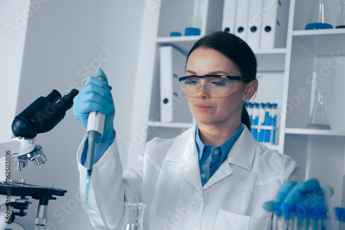 A passionate female scientist is conducting a groundbreaking experiment in a stateoftheart lab, showcasing her commitment to cuttingedge research in biochemistry and microbiology photo