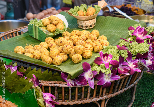 A Thai dish called Moo Sarong uses yellow noodles wrapped around pork balls.

