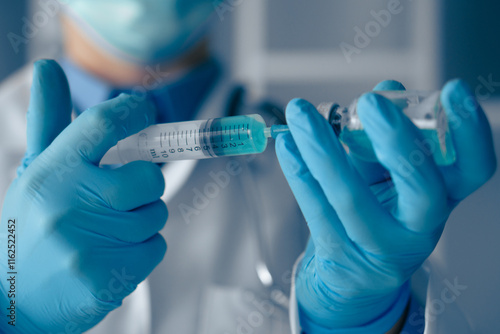 A Medical Professional is meticulously preparing a syringe filled with a vaccine in a clinical setting, ensuring all health and sanitation protocols are strictly adhered to for patient safety photo