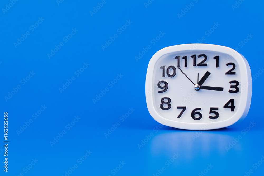 custom made wallpaper toronto digitalClock tells the time of work and life appointments. Working on time. White alarm clock on a blue screen.