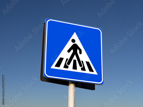 Close-up view of a blue pedestrian sidewalk sign