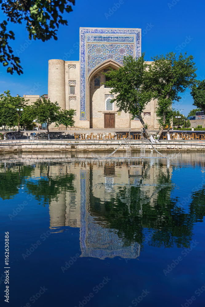 Nadir Divanbegi Khanaka reflecting in a pool in Bukhara Nadir Divanbegi Khanaka reflecting in a pool in Bukhara