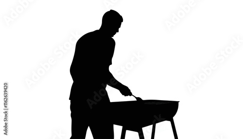 Silhouette of man grilling on barbecue