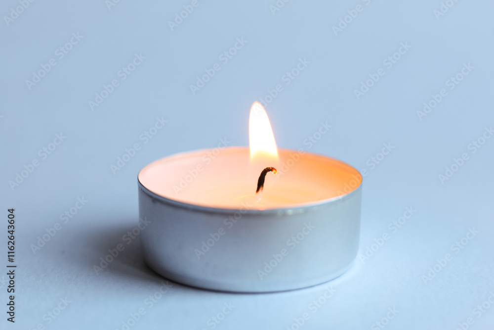 Candle on light background, close-up, space for text Candle on light background, close-up, space for text