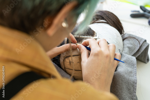 Close-Up of Needlework in Handcrafted Wig Production photo