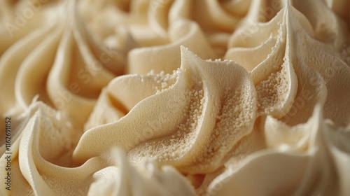 Close-up of swirls of creamy, pale-yellow frosting.