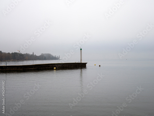 Lighthouse on the lake of Biel (Bienne) with fogy weather in winter, Canton Bern, Switzerland photo