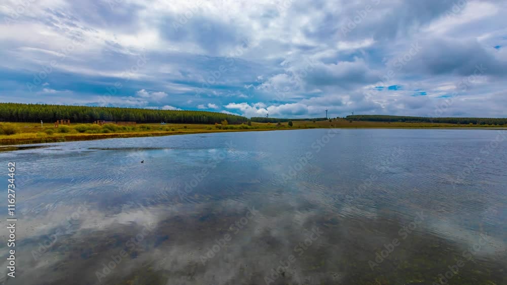 Nature time lapse capturing tranquil reflections at Hebei Sehanba Moon Lake during changing weather conditions Nature time lapse capturing tranquil reflections at Hebei Sehanba Moon Lake during changing weather conditions