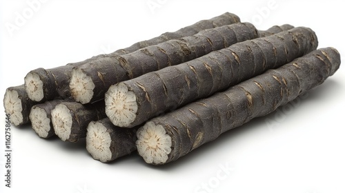 Stack of fresh black salsify roots, cut ends visible, isolated on white.