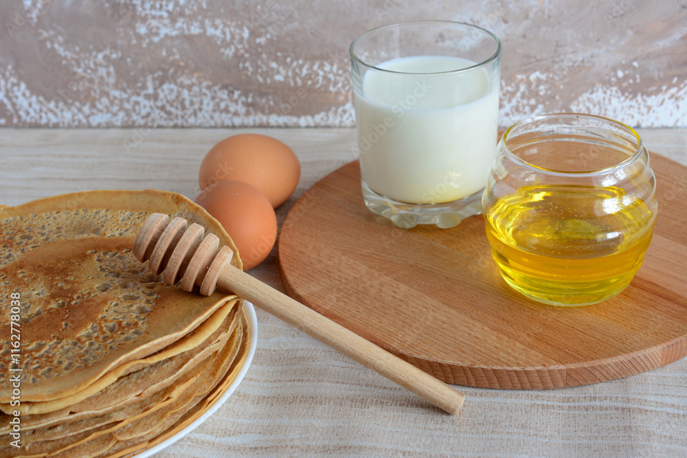a plate with pancakes on it and a cutting board with milk and honey a plate with pancakes on it and a cutting board with milk and honey