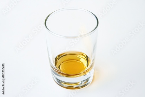 A clear glass filled with transparent liquid sitting on a flat surface