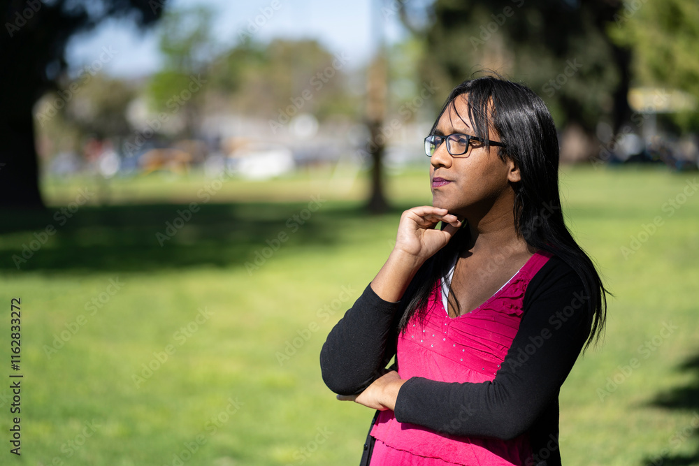 Latin transgender woman with concentrated expression lost in her thoughts Latin transgender woman with concentrated expression lost in her thoughts
