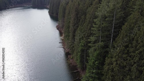 Wallpaper Mural An aerial escape over a tranquil lake and rolling green hills in cloudy weather Torontodigital.ca