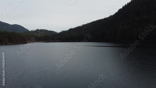 Wallpaper Mural Serene moments over a still lake and forested hills on a moody day Torontodigital.ca