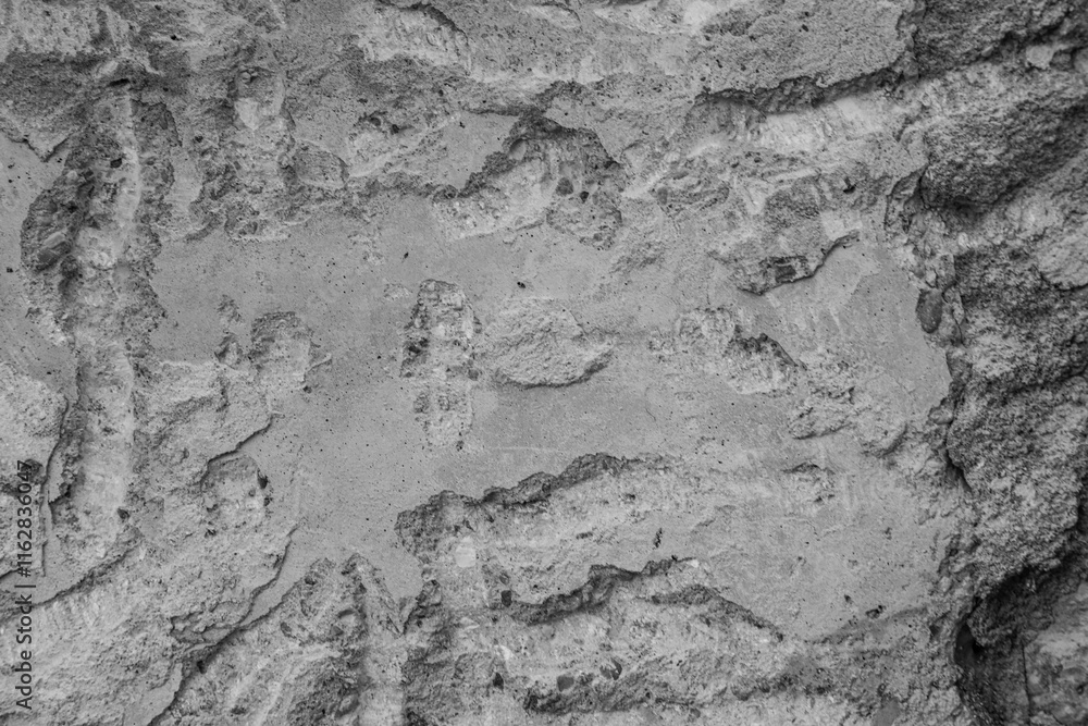 Fototapeta premium Rough uneven surface of a concrete wall.