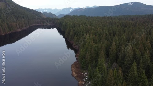 Wallpaper Mural Flying over a quiet lake surrounded by green mountains on an overcast day" Torontodigital.ca