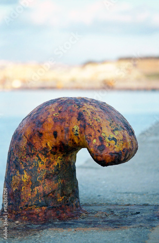 Close-up of a mooring iron bollard on a pier photo