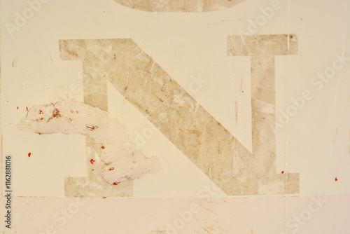 letter n deleted on pale yellow ochre photo