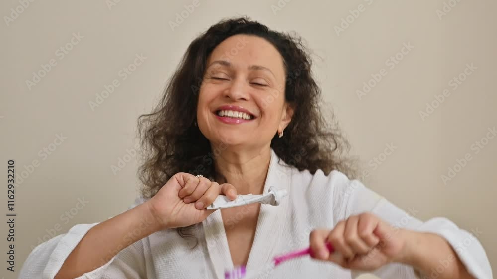 Woman promoting dental health while holding toothbrush and toothpaste with a smile