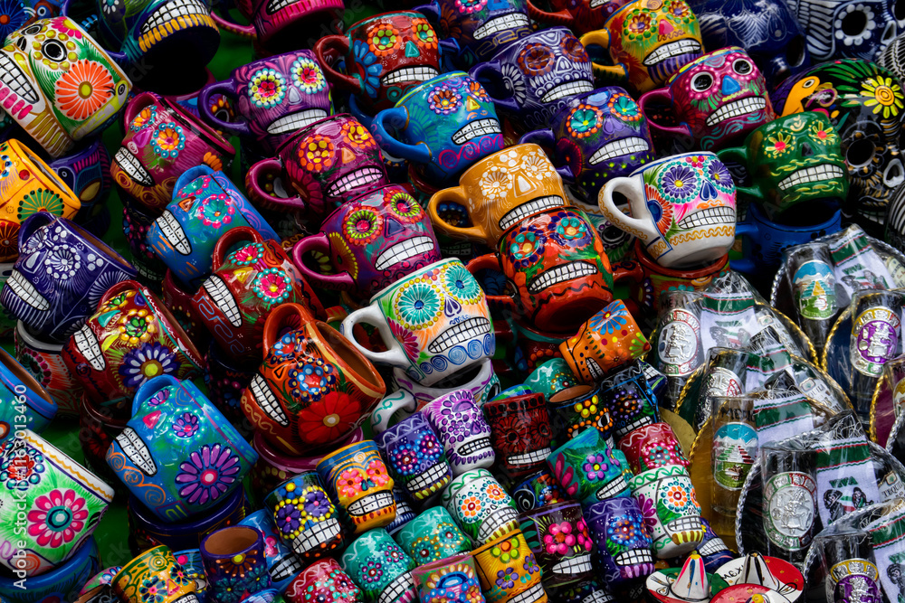 Fototapeta premium Street sale of handicrafts alluding to the Day of the Dead in Mexico City. Cups decorated with colorful skulls.