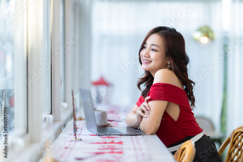 Obraz na płótnie asian freelance people business female talking making using casual working with laptop computer and coffee at home in the living room indoors Decoration During Christmas x-mas and New Year holidays. w salonie
