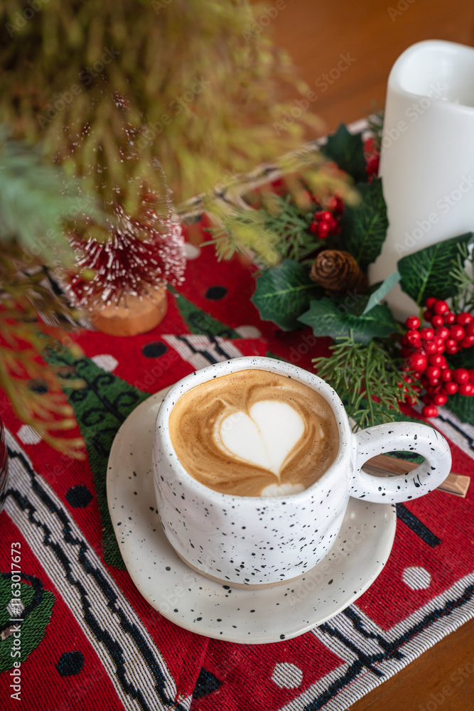 Close up of Hot coffee latte with latte art milk foam in cup mug with Xmas decors and Xmas tree baubles on wood desk Celebrating Merry Christmas and New year,Merry x-mas