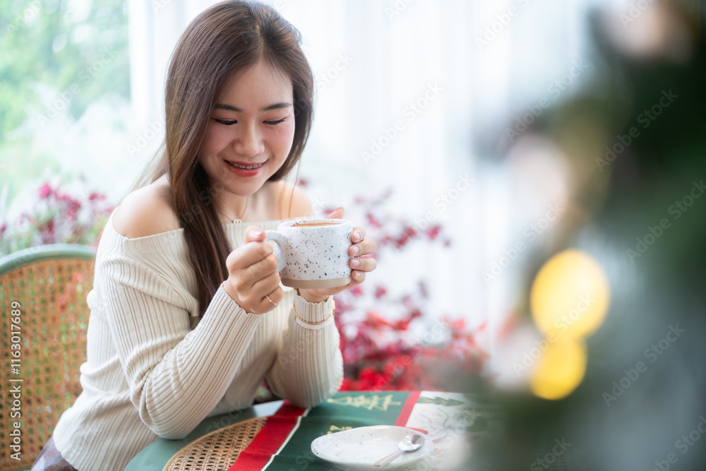 Portrait beautiful asian woman holding of positive the having cup of coffee,milk or chocolate at home in the living room indoors Decoration During Christmas x-mas and New Year holidays.