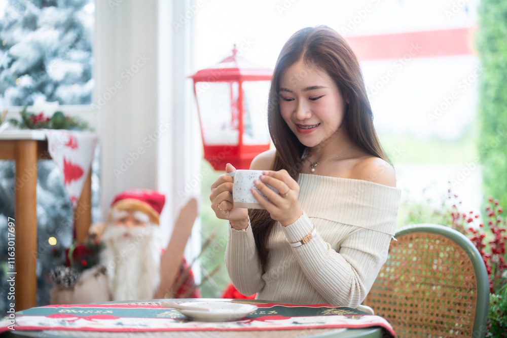 Portrait beautiful asian woman holding of positive the having cup of coffee,milk or chocolate at home in the living room indoors Decoration During Christmas x-mas and New Year holidays.