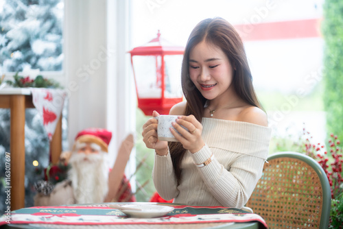 Portrait beautiful asian woman holding of positive the having cup of coffee,milk or chocolate at home in the living room indoors Decoration During Christmas x-mas and New Year holidays.