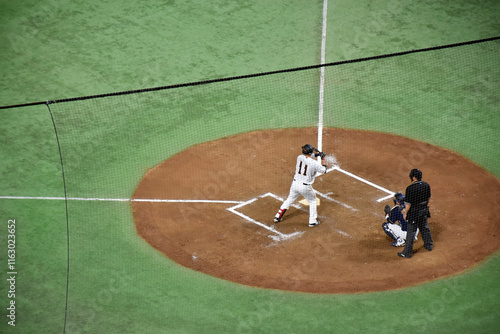 Photos Baseball players in action on a mound, surrounded by green turf, showcasing the intensity and skill of the game