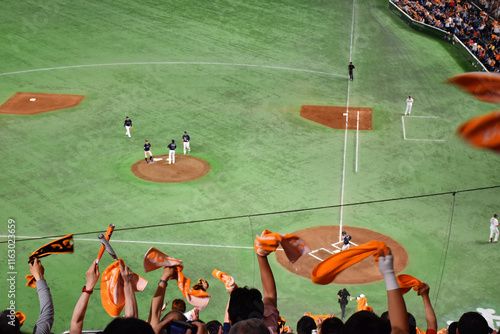 Obraz na plátne Baseball players in action on a mound, surrounded by green turf, showcasing the intensity and skill of the game
