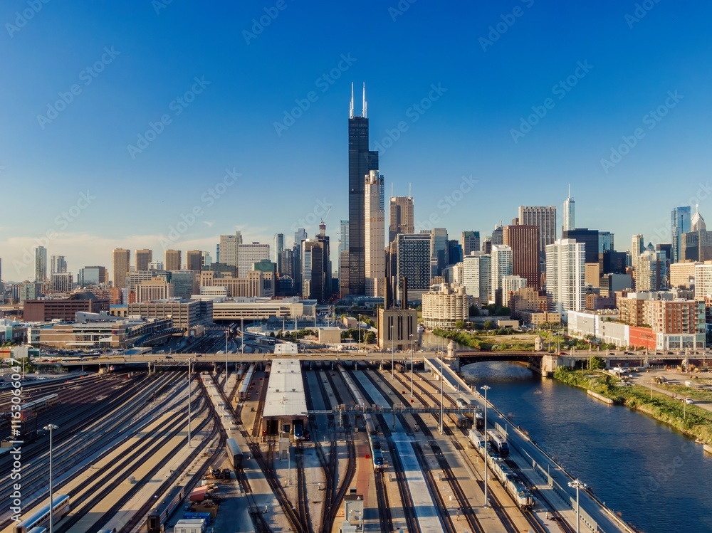 Fototapeta premium Chicago Union Station, train yard, and city skyline. Aerial view of train tracks and commuter rail cars. Amtrak Chicago, Chicago, Illinois, United States