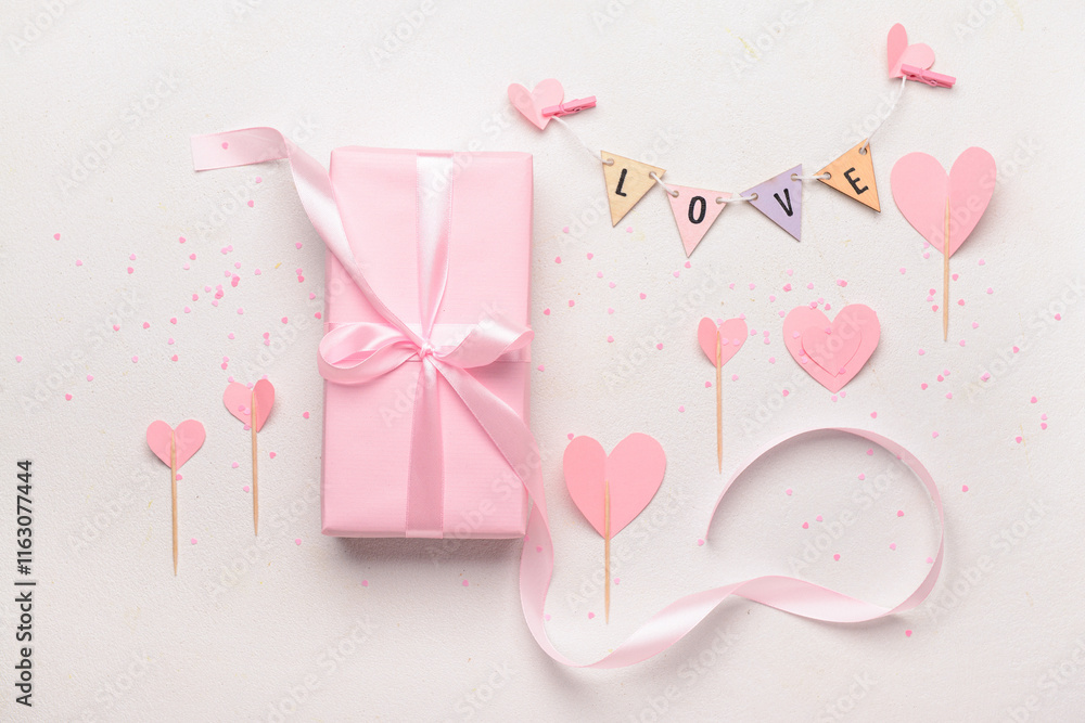 Composition with gift box, word LOVE and paper hearts for Valentine's Day celebration on white background Composition with gift box, word LOVE and paper hearts for Valentine's Day celebration on white background