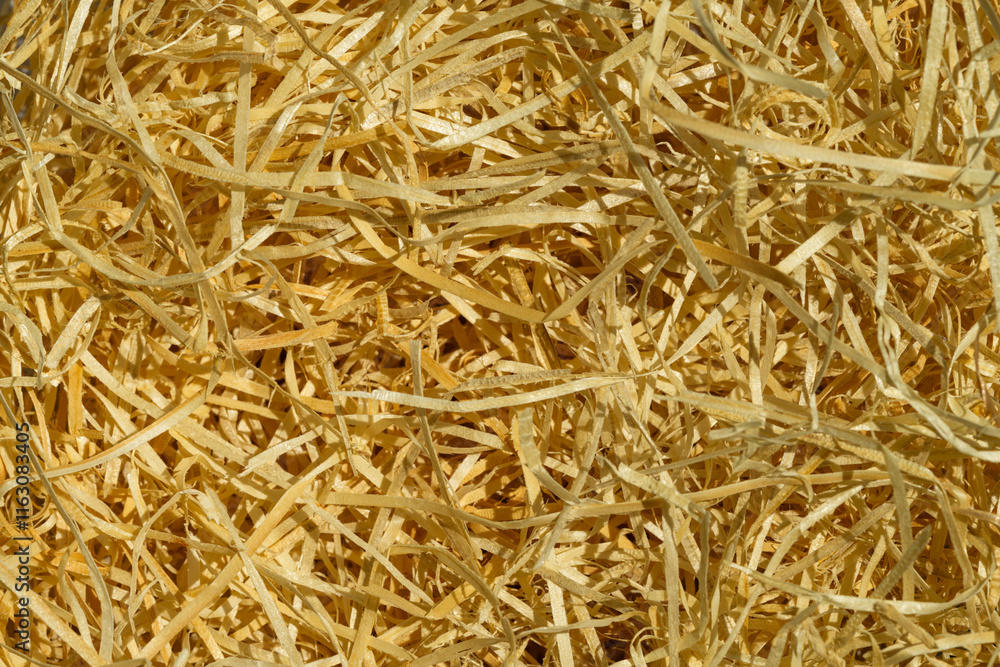 Packaging material. Straw for packing fragile items. Top view of natural color shredded wood excelsior for filling inside box when sending package Packaging material. Straw for packing fragile items. Top view of natural color shredded wood excelsior for filling inside box when sending package