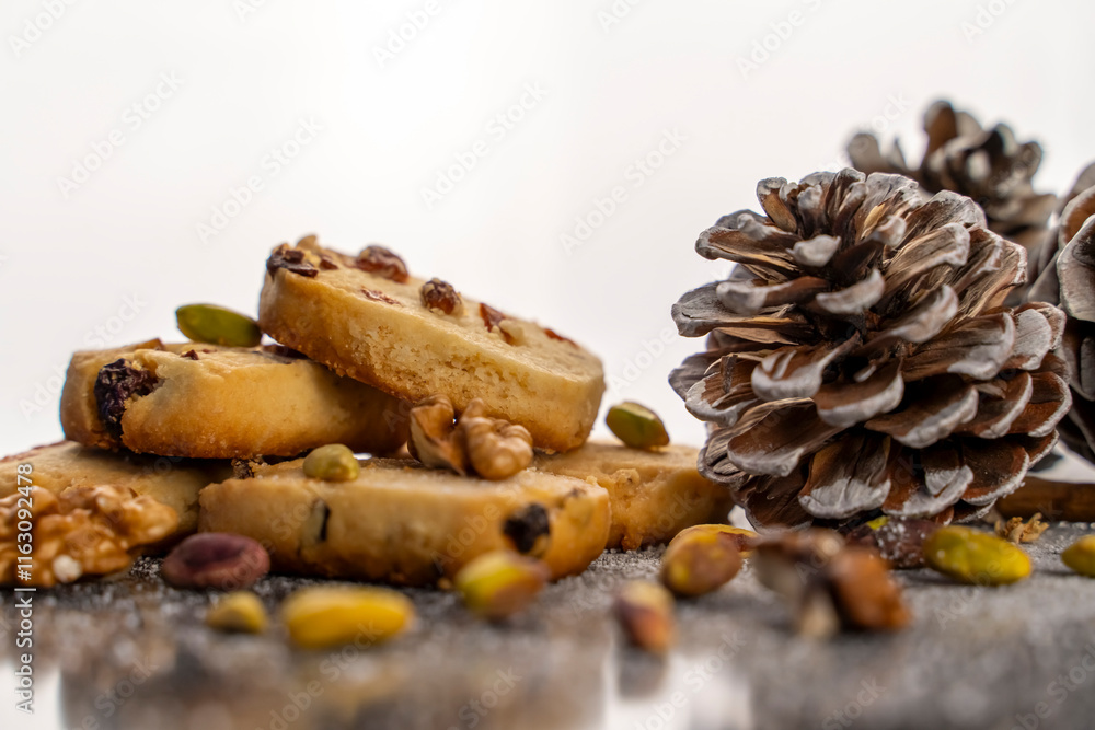 Fototapeta premium Pine nut cookies on black and white background with pine cones next to them kitchen concept
