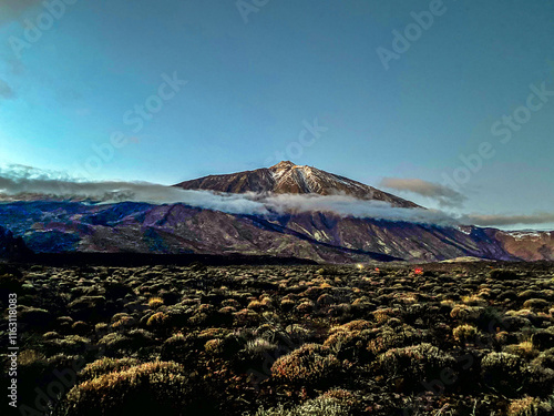 Volcano Teide Tenerife Canary Islands Spain with white clouds under blue clear sky photo