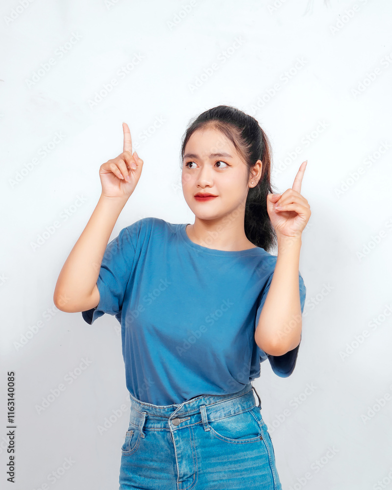 young asian woman seen pointing towards a certain direction young asian woman seen pointing towards a certain direction