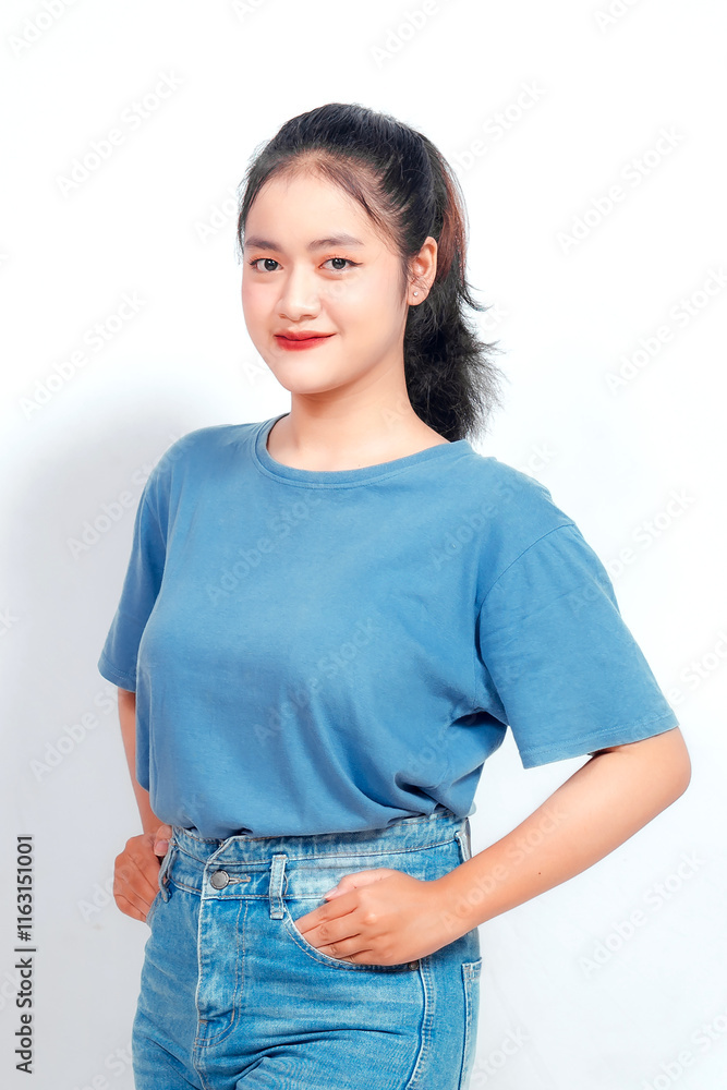 Obraz premium Portrait of a confident smiling girl standing on white background