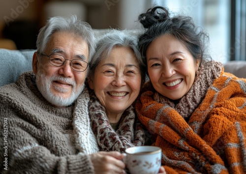 Warm Companionship Elderly Couple and Volunteer Sharing Tea and Smiles in Cozy Winter Embrace photo