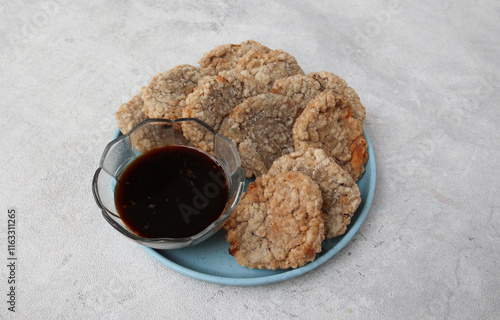 pempek kulit or peel fish cake. made from skin of mackerel fish. served with spicy and sour sauce, cucumber and prawn powder. it is very popular in south sumatera. famous food when ramadan month. photo