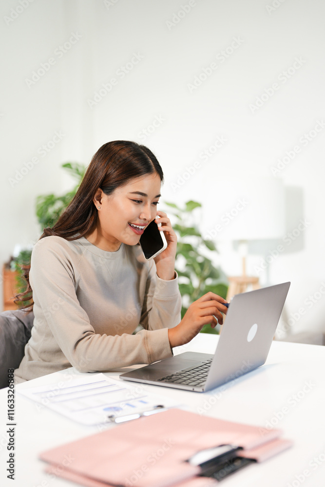 Asian business woman making a phone call and smiling indoor Asian business woman making a phone call and smiling indoor